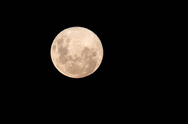 A supermoon rises in the sky at the city of Vina del Mar