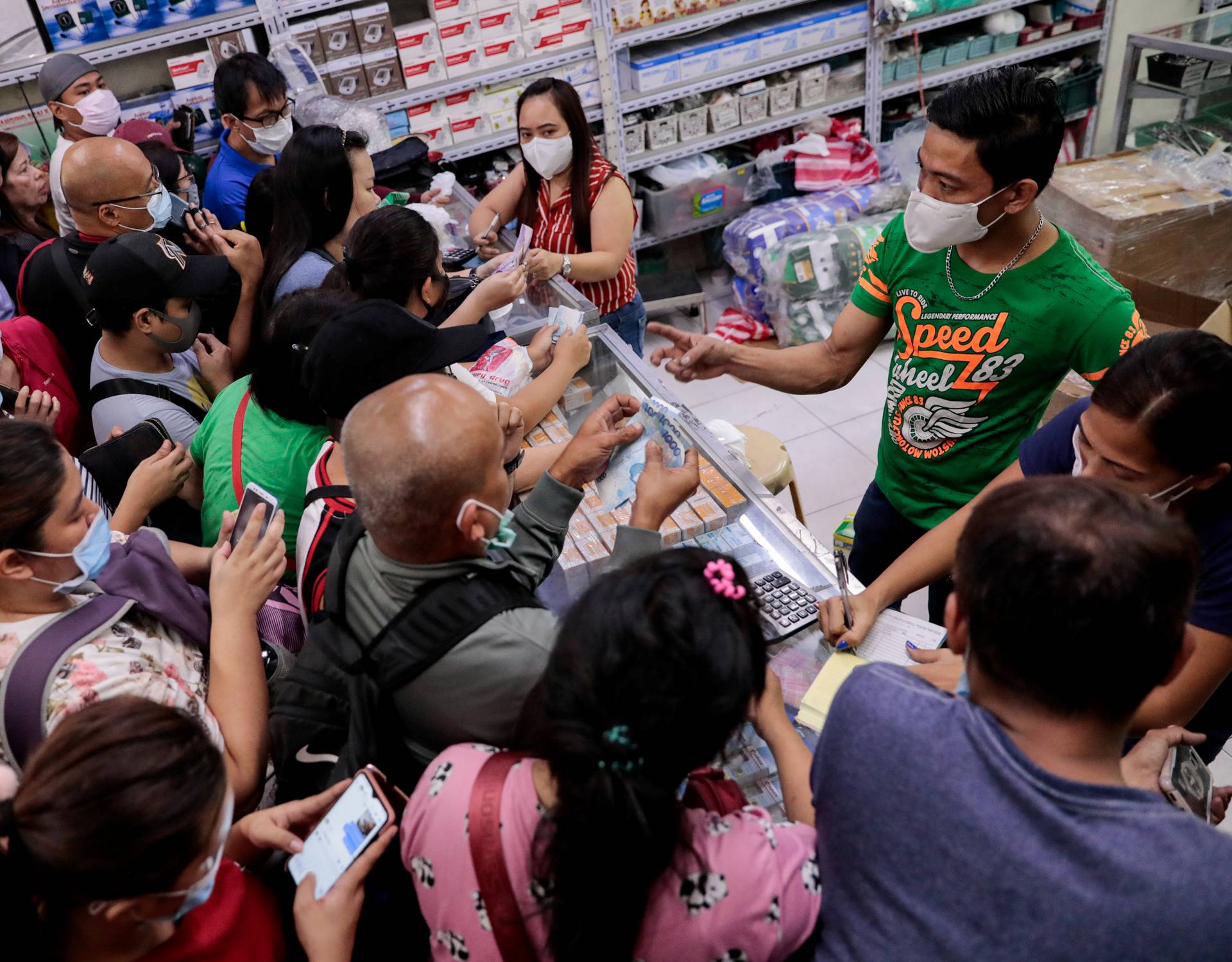 People scramble to buy face masks in a medical supply store a day after Philippine government confirmed first novel coronavirus case