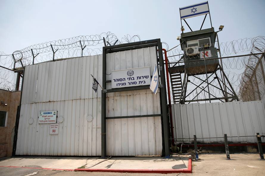 An Israeli flag is seen next to the gate of the Megiddo Prison