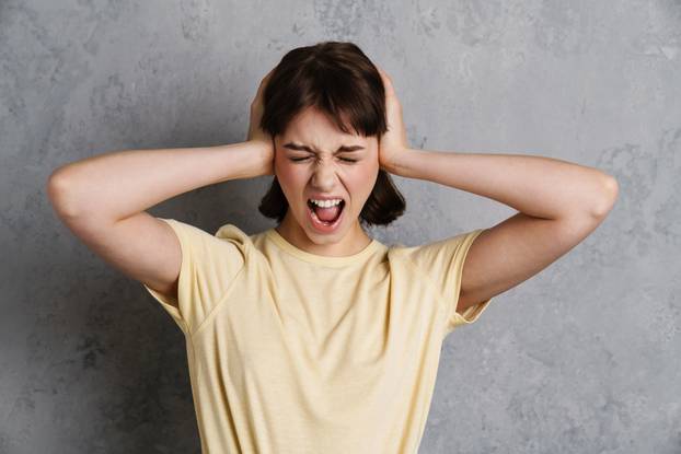 Worried stressed young woman suffering from a migraine