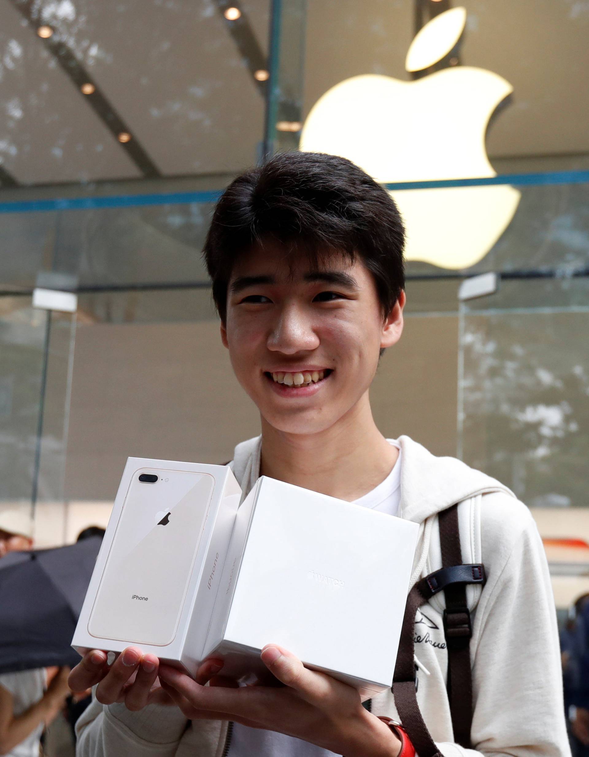 Yokoyama holds Apple's new iPhone 8 Plus and new Apple Watch after purchasing them at the Apple Store in Tokyo's Omotesando shopping district