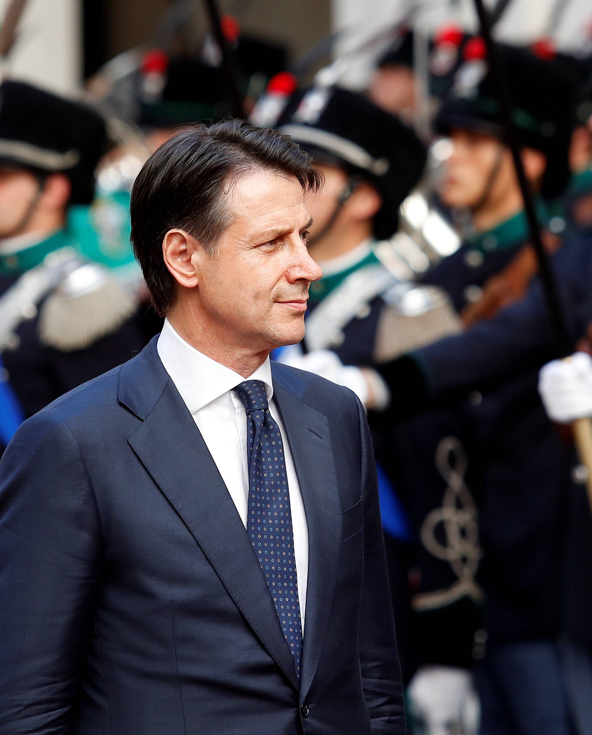 Italy's Prime Minister Giuseppe Conte reviews the guard of honour at Chigi palace in Rome