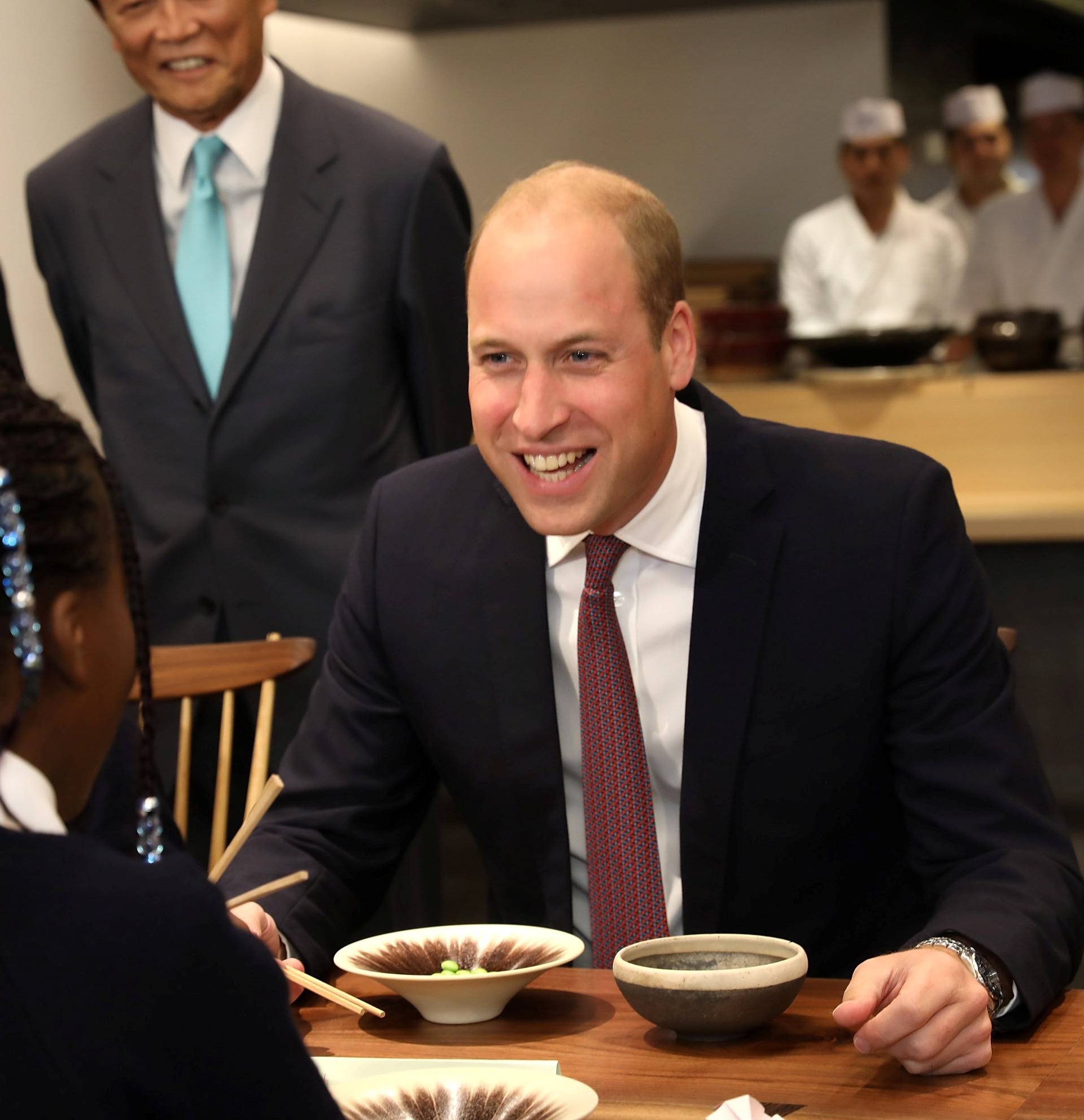 Britain's Prince William joins local school children from St Cuthbert with St Matthias CE Primary School at a copper beating workshop during the official opening of Japan House in London