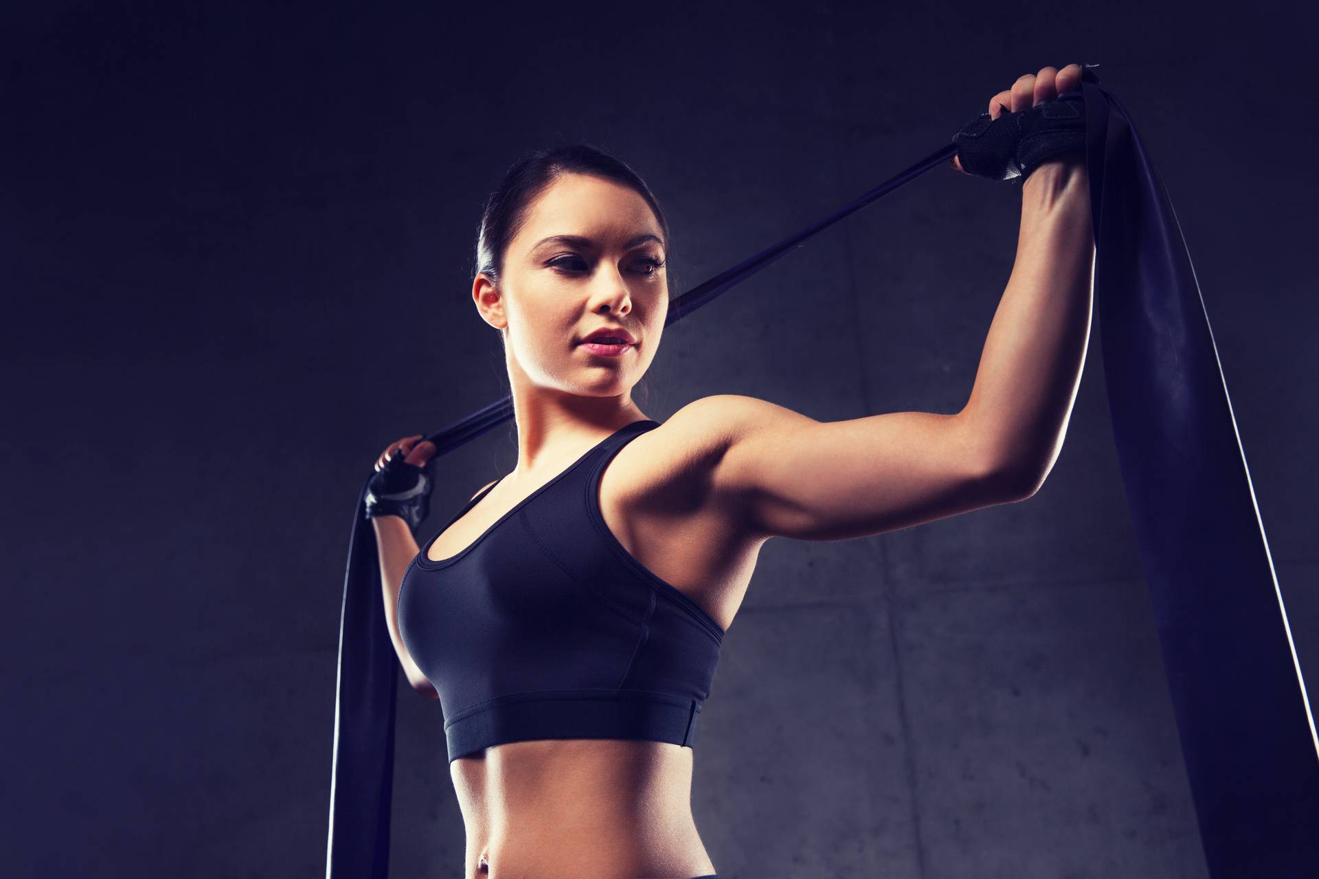 woman with expander exercising in gym