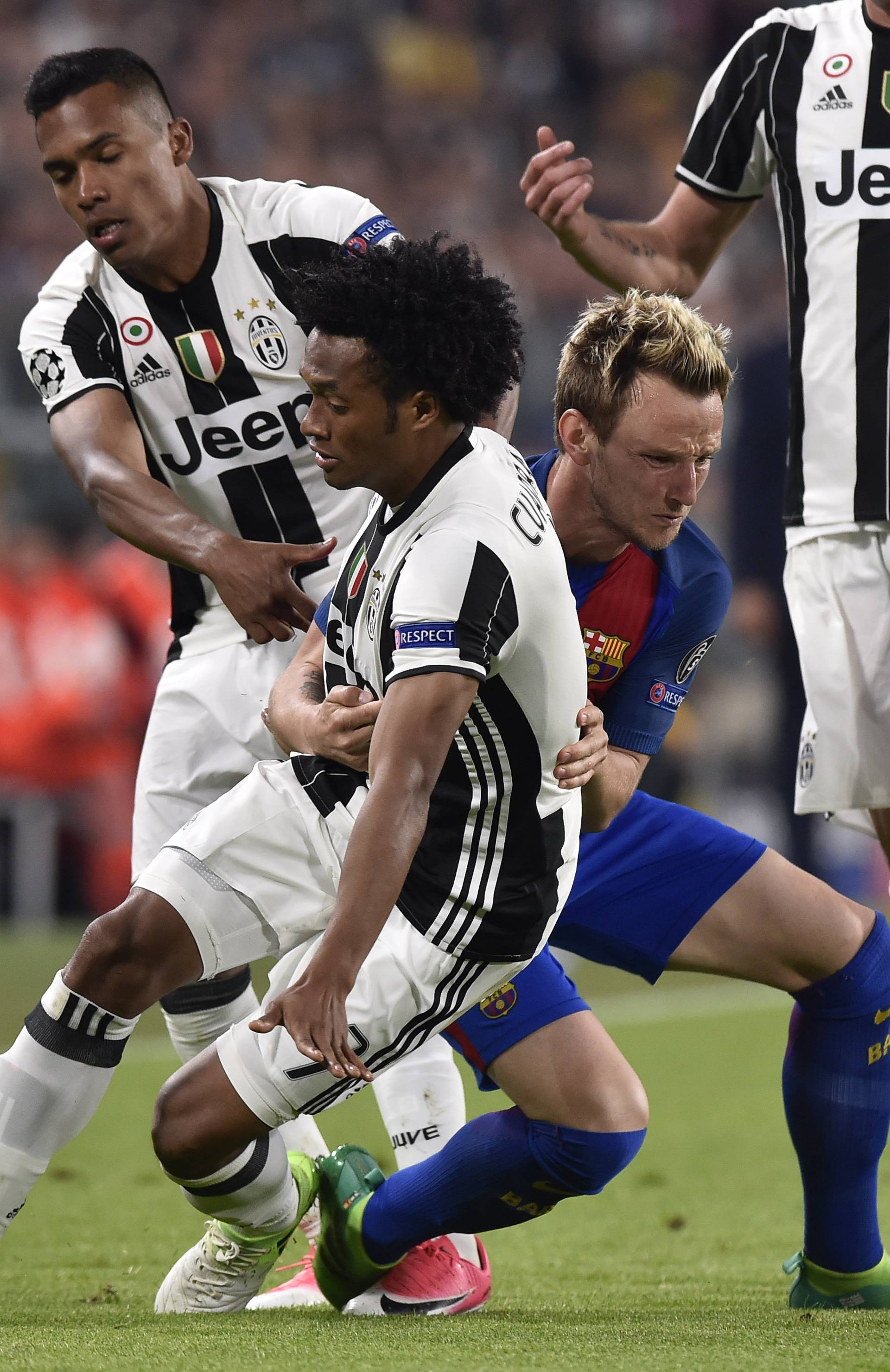 Barcelona's Ivan Rakitic fouls Juventus' Juan Cuadrado
