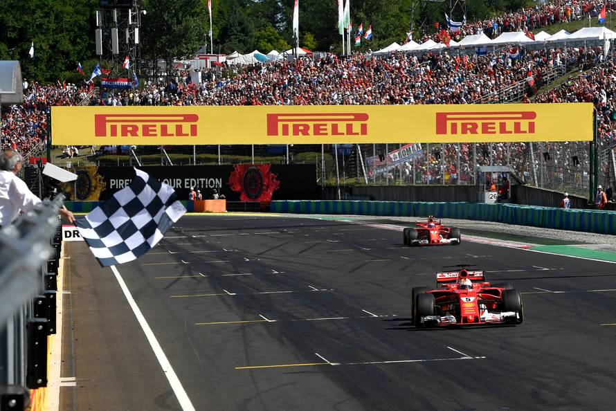 Ferrari's German driver Sebastian Vettel drives over the finish line during the Formula One Hungarian Grand Prix at the Hungaroring racing circuit in Budapest