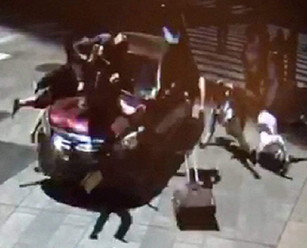 Pedestrians are struck by a vehicle travelling through Times Square, in a still image from security video