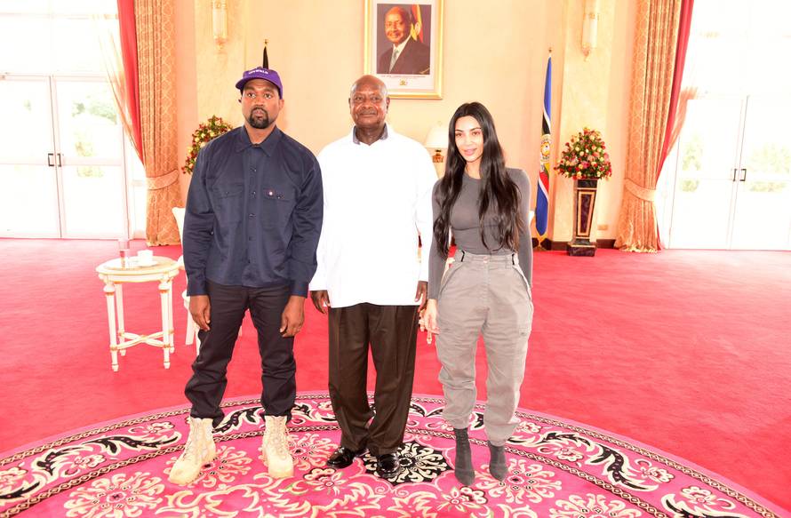 Rapper Kanye West and Kim Kardashian pose for a photograph with Uganda's President Yoweri Museveni when they paid a courtesy call at State House, Entebbe