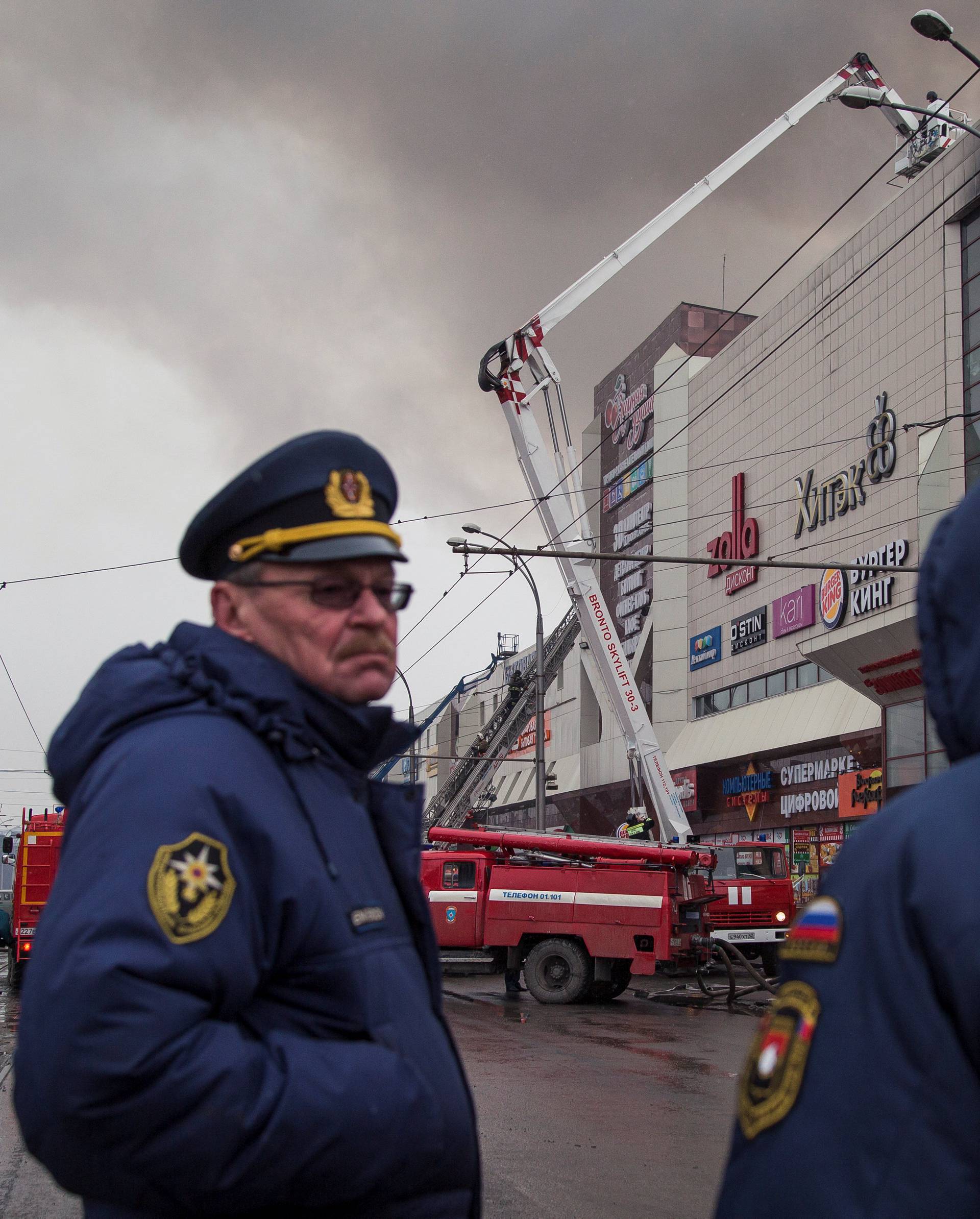 Members of the Emergency Situations Ministry work at the scene of a fire in a shopping mall in Kemerovo