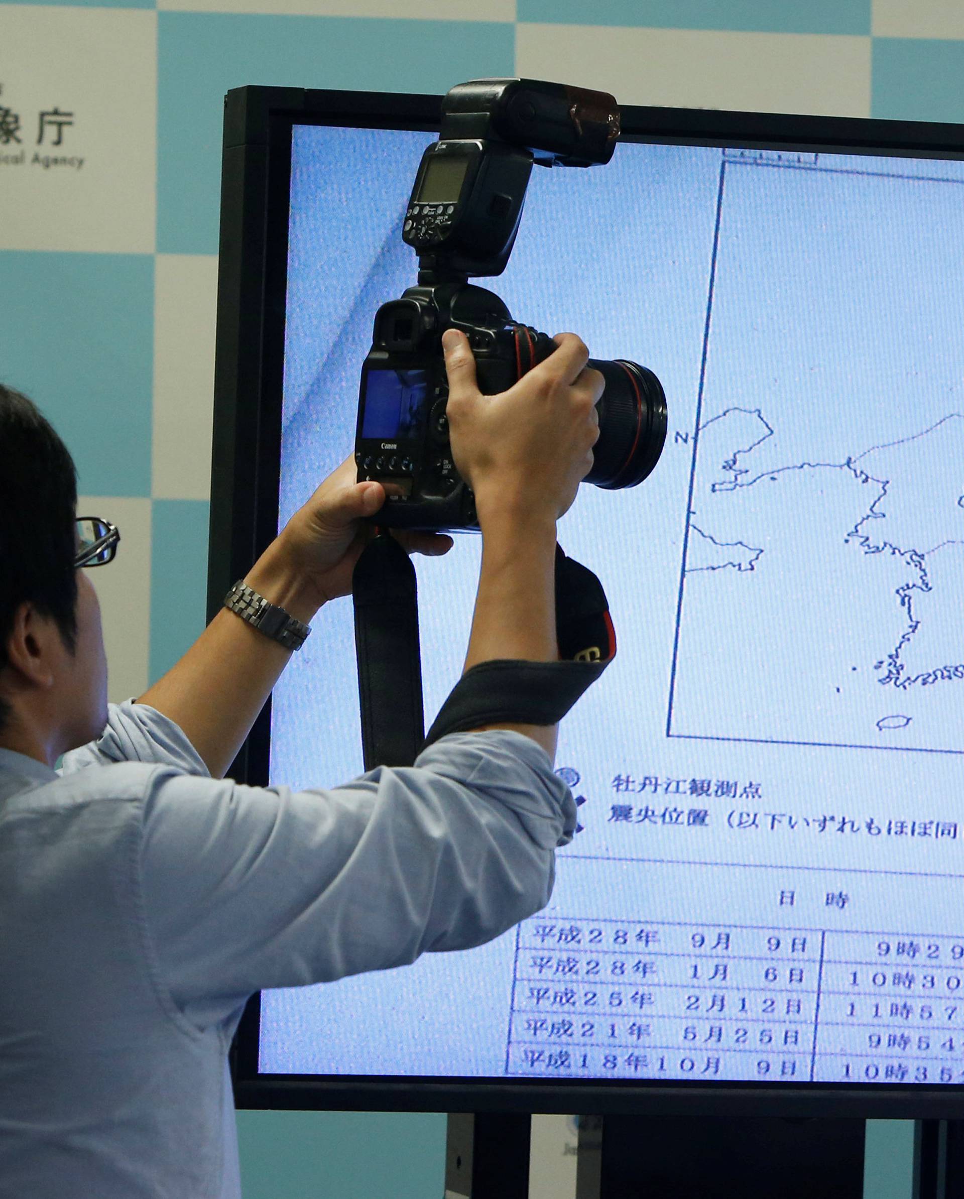 A photographers takes picture of a monitor showing the seismic event was indicated on North Korea and observed in Japan during a news conference at the Japan Meteorological Agency in Tokyo