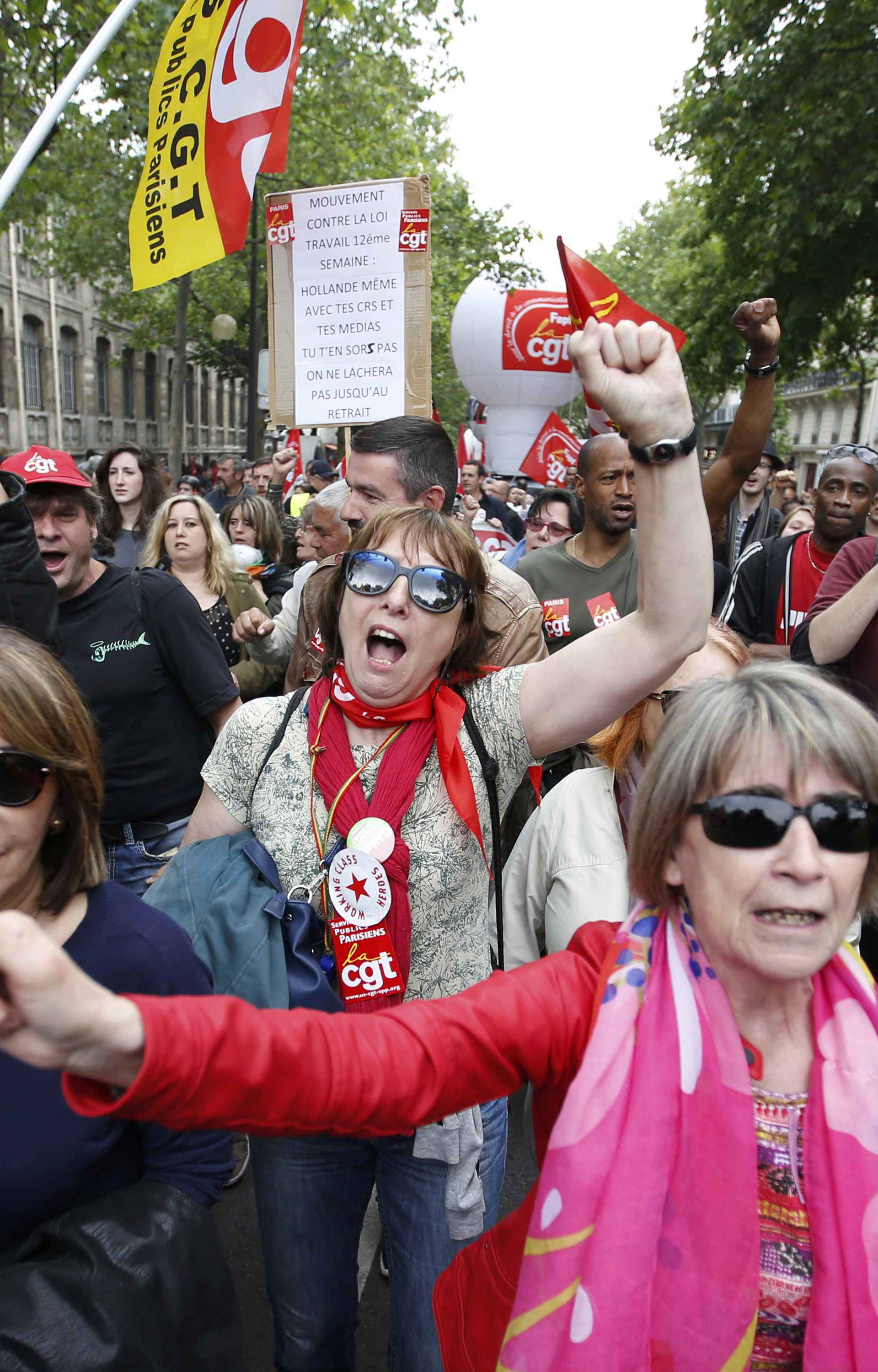 French labour union members march during a demonstration in protest of the government's proposed labor law reforms in Paris