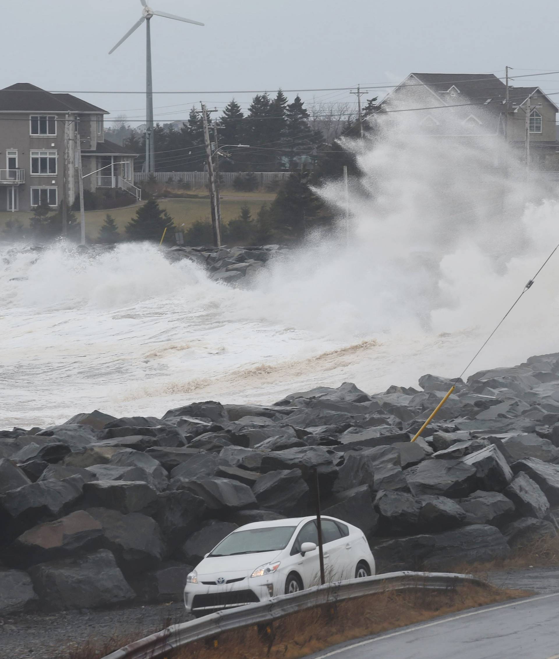 A storm surge from the Atlantic Ocean hits a break wall during Winter Storm Grayson in Cow Bay
