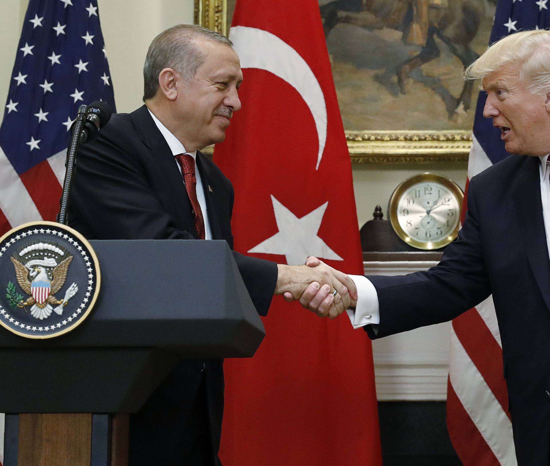 Turkey's President Erdogan shakes hands with U.S. President Trump in the Roosevelt Room of the White House in Washington