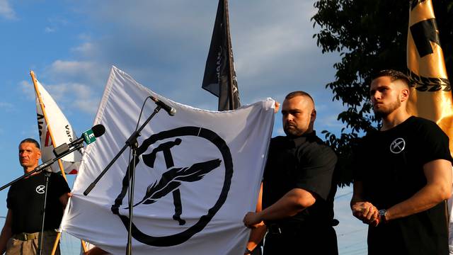 Leaders of a new Hungarian extreme right group unfurl the flag of their new movement, to be called Force and Determination, at a rally in Vecses