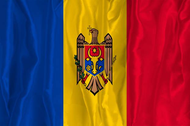 The flag of Moldova on a silk background is a great national symbol. Texture of fabrics The official state symbol of the country