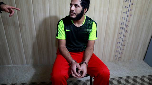 An Islamic State member listens to a counter-terrorism agent in Sulaimaniya