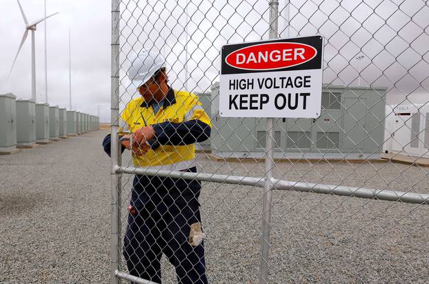  A worker checks the main gate for the compound housing the Hornsdale Power Reserve, featuring the world