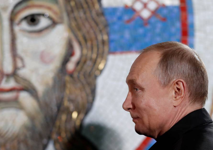 Russian President Vladimir Putin stands during his visit to the St Sava temple in Belgrade
