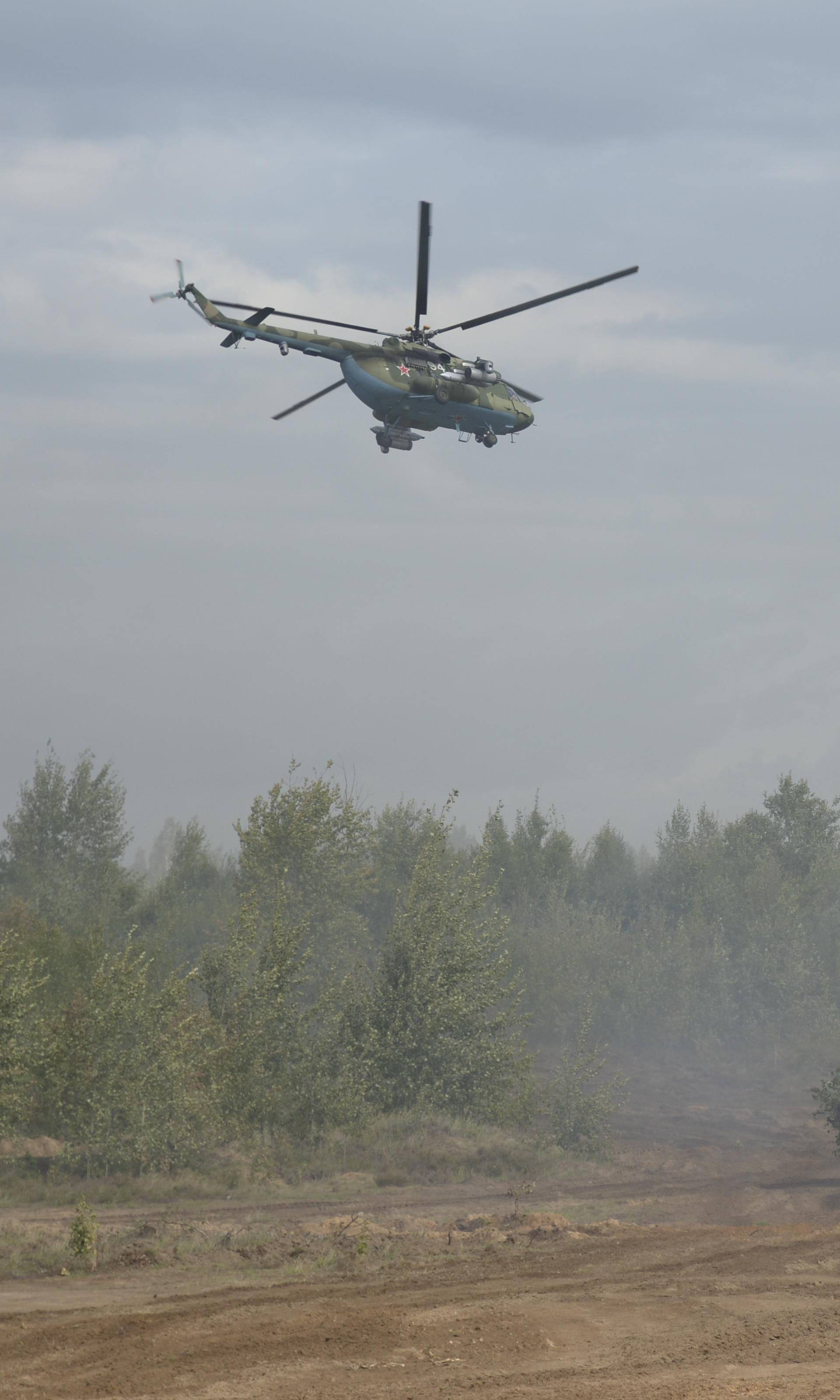 Helicopters and an armoured vehicle are seen during the Zapad-2017 war games in Belarus