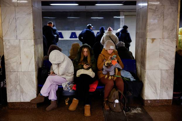 People take shelter inside a metro station during a Russian military attack, in Kyiv