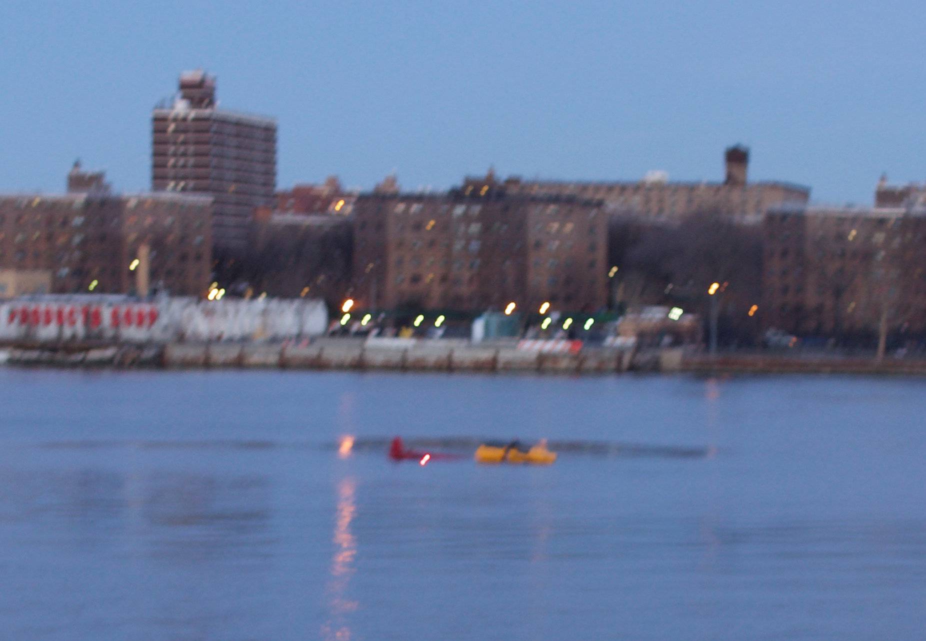 A helicopter is seen crashed in New York City's East River
