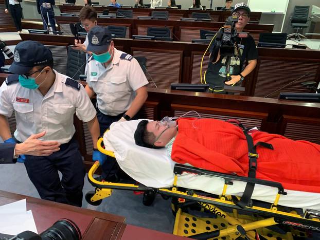Pro-democracy lawmaker Gary Fan is carried on a stretcher carry away on a stretcher after clashes with pro-Beijing lawmakers during a meeting for control of a meeting room to consider the controversial extradition bill, in Hong Kong