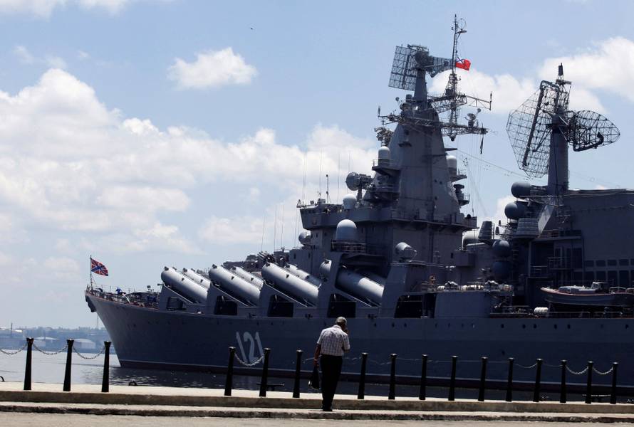 FILE PHOTO: A man walks beside the Russian Moskva Guided Missile Cruiser docked at Havana port
