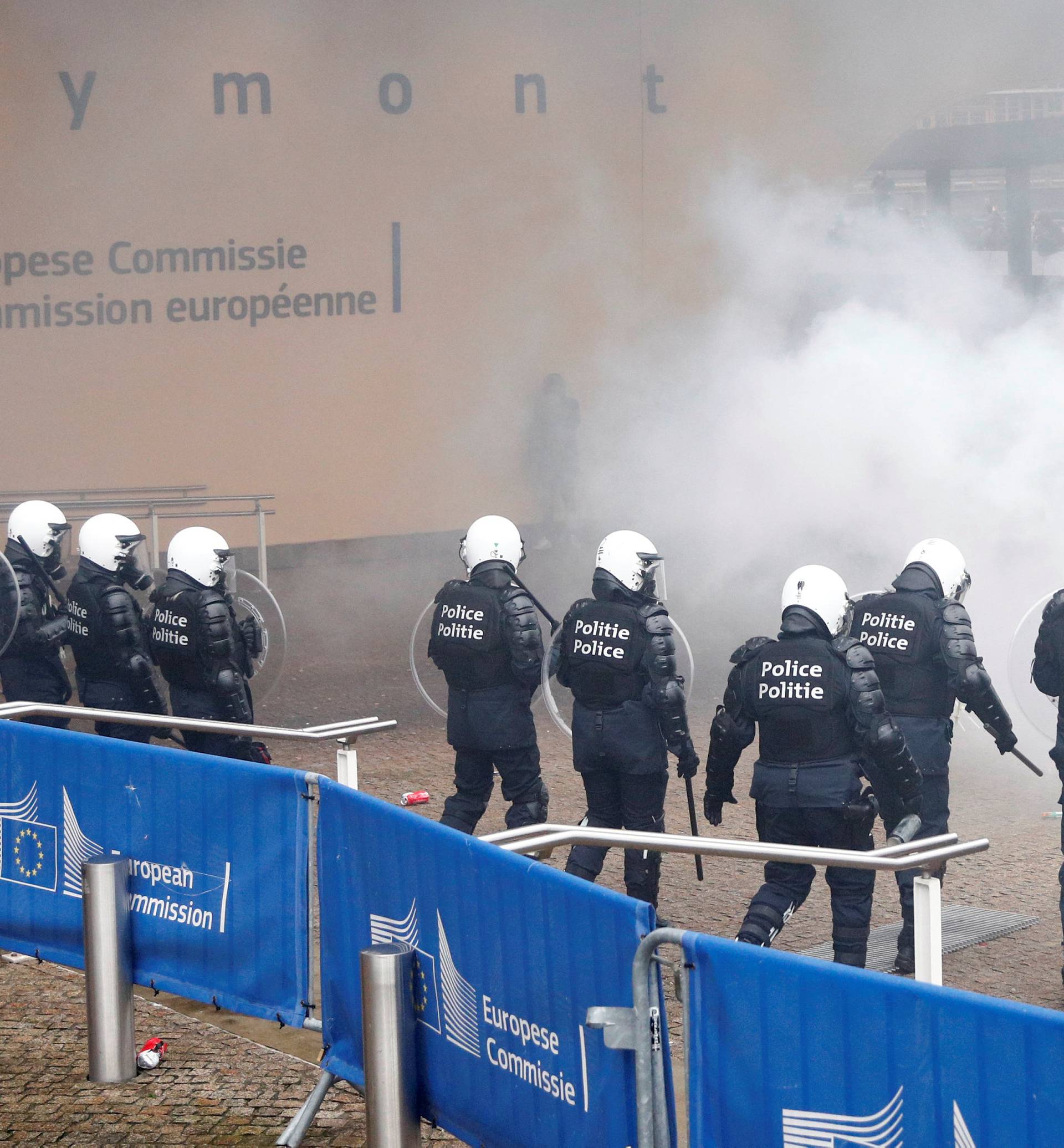 Police officers face off with far-right supporters during a protest against Marrakesh Migration Pact, outside European Commission headquarters, in Brussels