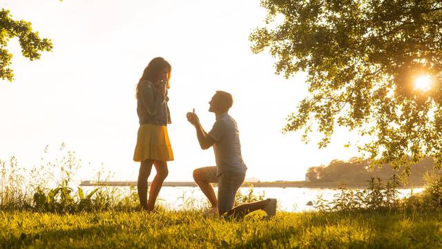 Loving man making a wedding offer to his beautiful girlfriend. Be my wife concept.