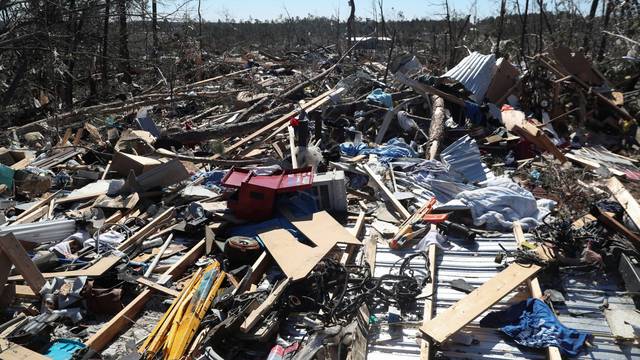 Debris lays outside a house devastated after two deadly back-to-back tornadoes, in Beauregard, Alabama
