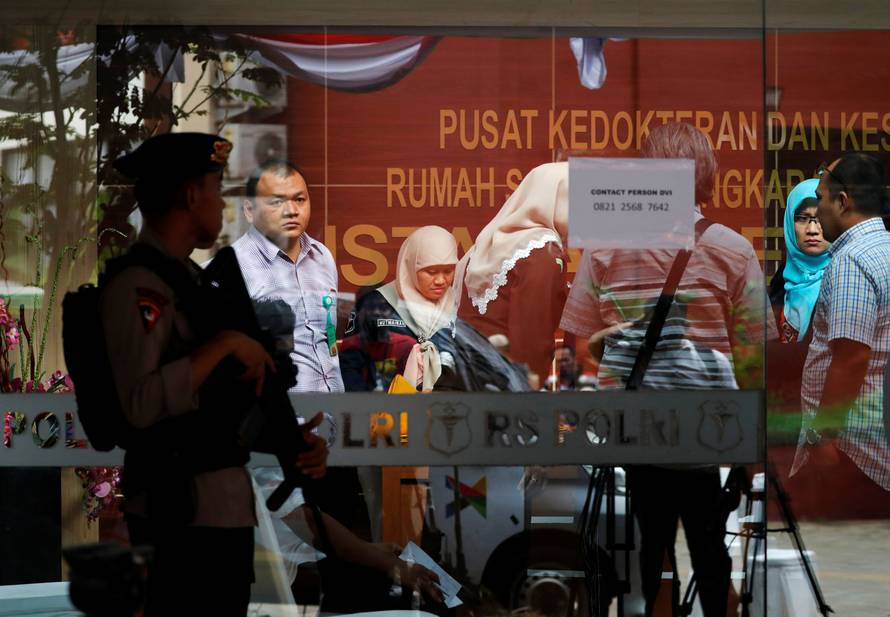 Colleagues of victims of the Lion Air flight JT610 crash are seen at a police hospital in Jakarta