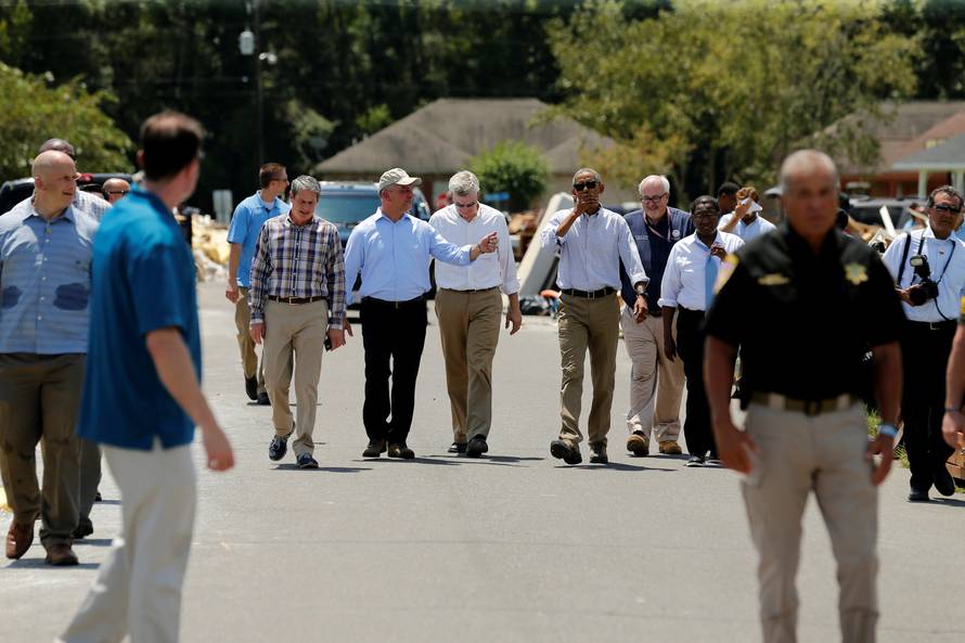 U.S. President Barack Obama tours a flood-affected neighborhood with U.S. Senator David Vitter, Louisiana Governor John Bel Edwards and U.S. Senator Bill Cassidy in Zachary