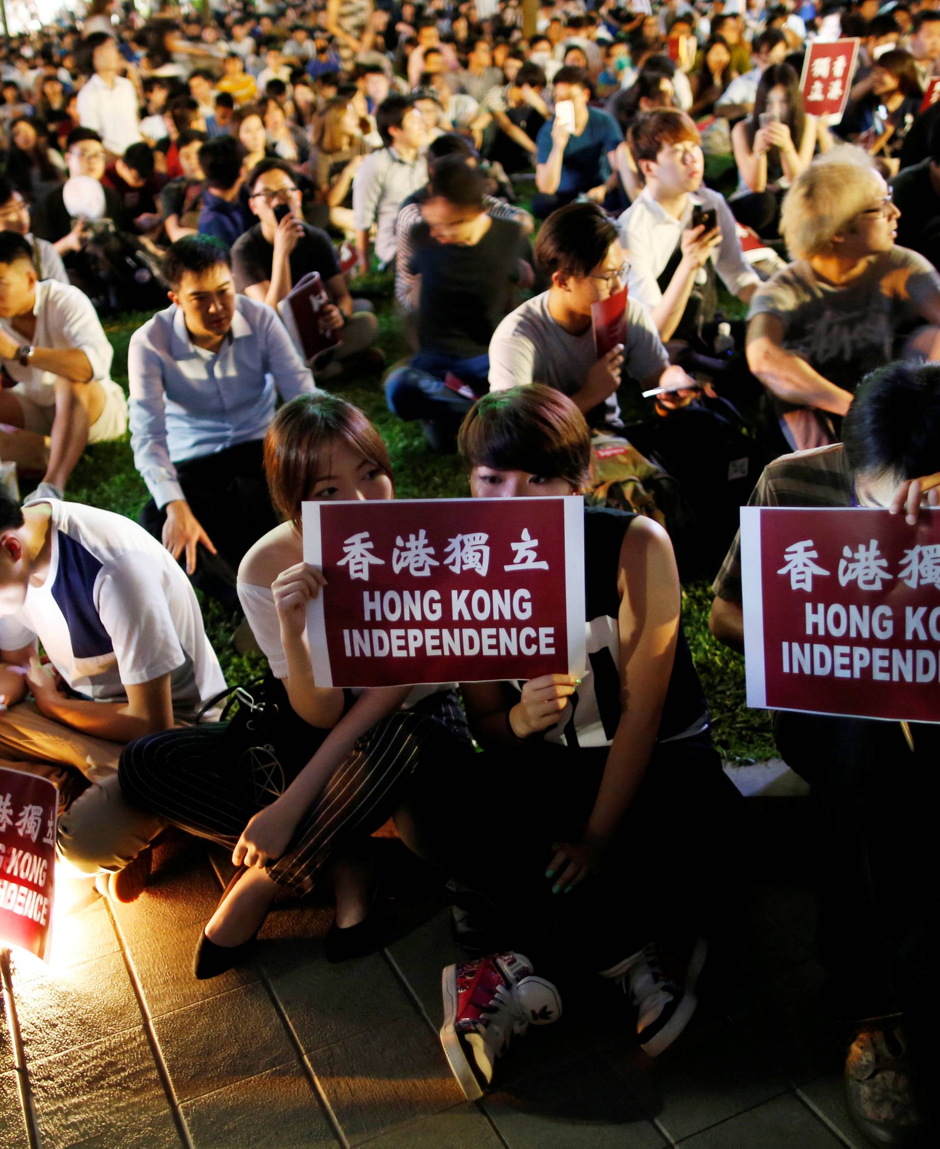 Protesters hold placards during a rally in support of independence advocates who have been barred from the Legislative Council elections in Hong Kong