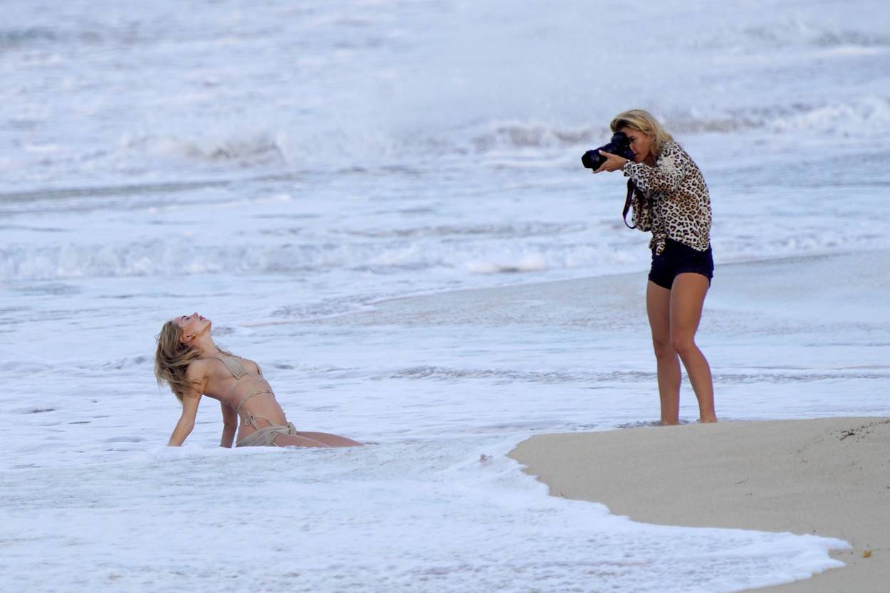 Kimberley Garner doing a photoshoot on a beach with fashion photographer Camellia Menard during holiday season in St-Barth