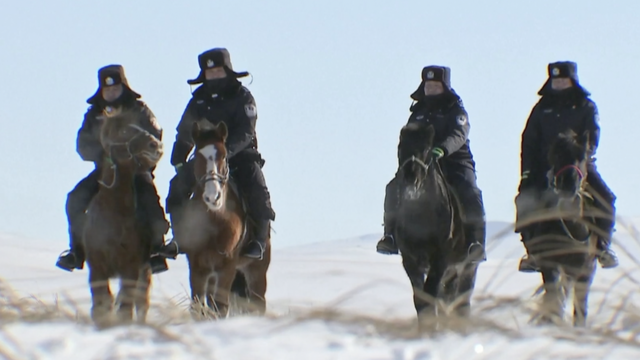 Kineski policajci patroliraju na konjima u dubokom snijegu u Unutarnjoj Mongoliji