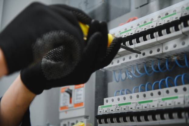 Electricians,Work,To,Connect,Electric,Wires,In,The,System,,Switchboard,