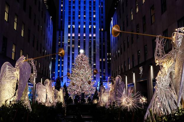 People watch the lighting of The Rockefeller Center Christmas Tree in New York City