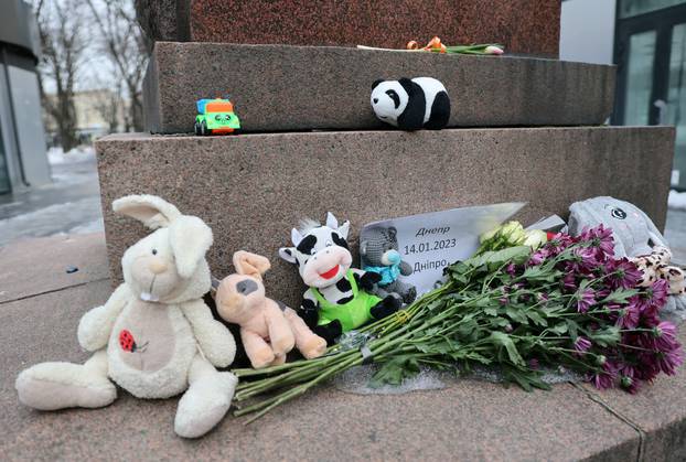 Toys and flowers are placed at an improvised memorial to the victims of the Russian missile strike in Dnipro, in Moscow