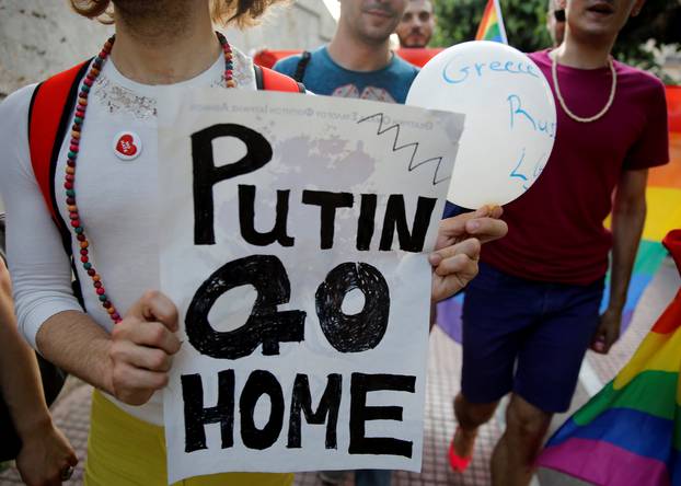 Supporters of the Greek Lesbian, Gay, Bisexual and Transgender community protest against a visit by Russian President Vladimir Putin in Athens