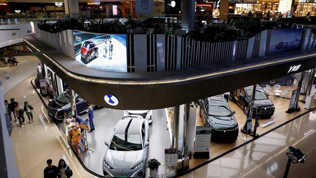 FILE PHOTO: Electric vehicle (EV) models are displayed at the booths of Denza and Chinese EV maker Voyah, at a shopping mall in Beijing