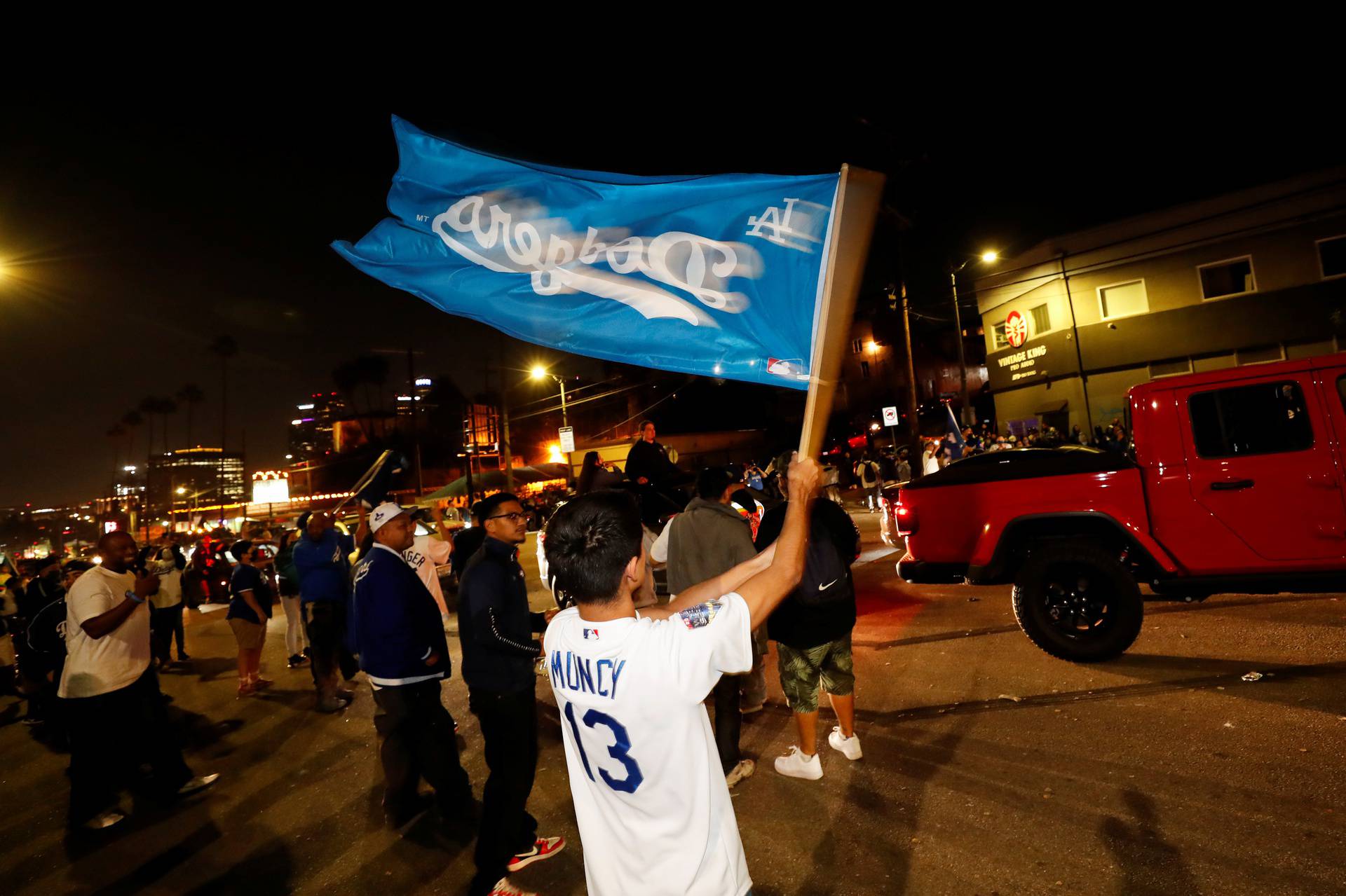 People celebrate Los Angeles Dodgers' victory at the end of game 6 of the 2020 World Series between Los Angeles Dodgers and Tampa Bay Rays, in Los Angeles, California