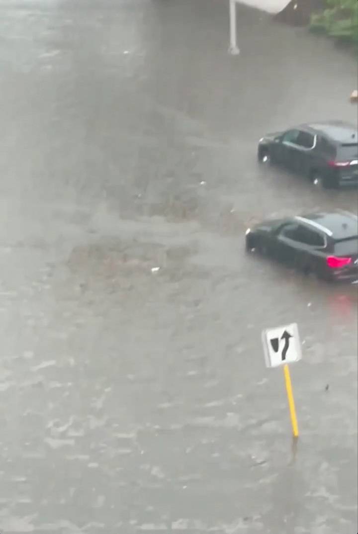 Cars are seen on a flooded street in Yonkers