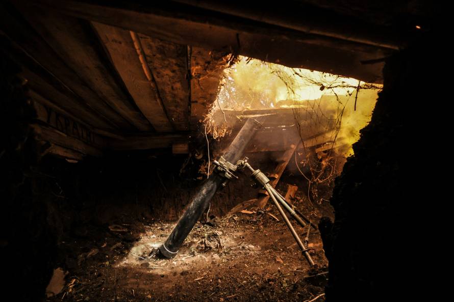Ukrainian servicemen fire a 120-mm mortar towards Russian troops at a frontline near the town of Chasiv Yar