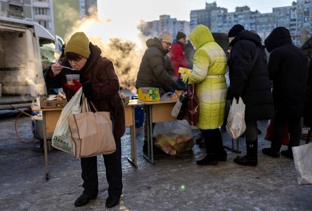 Residents receive food donations in a neighbourhood with electricity and heating outages following recent Russian attacks on Ukraine&rsquo;s civilian infrastructure during subzero temperatures in Kyiv
