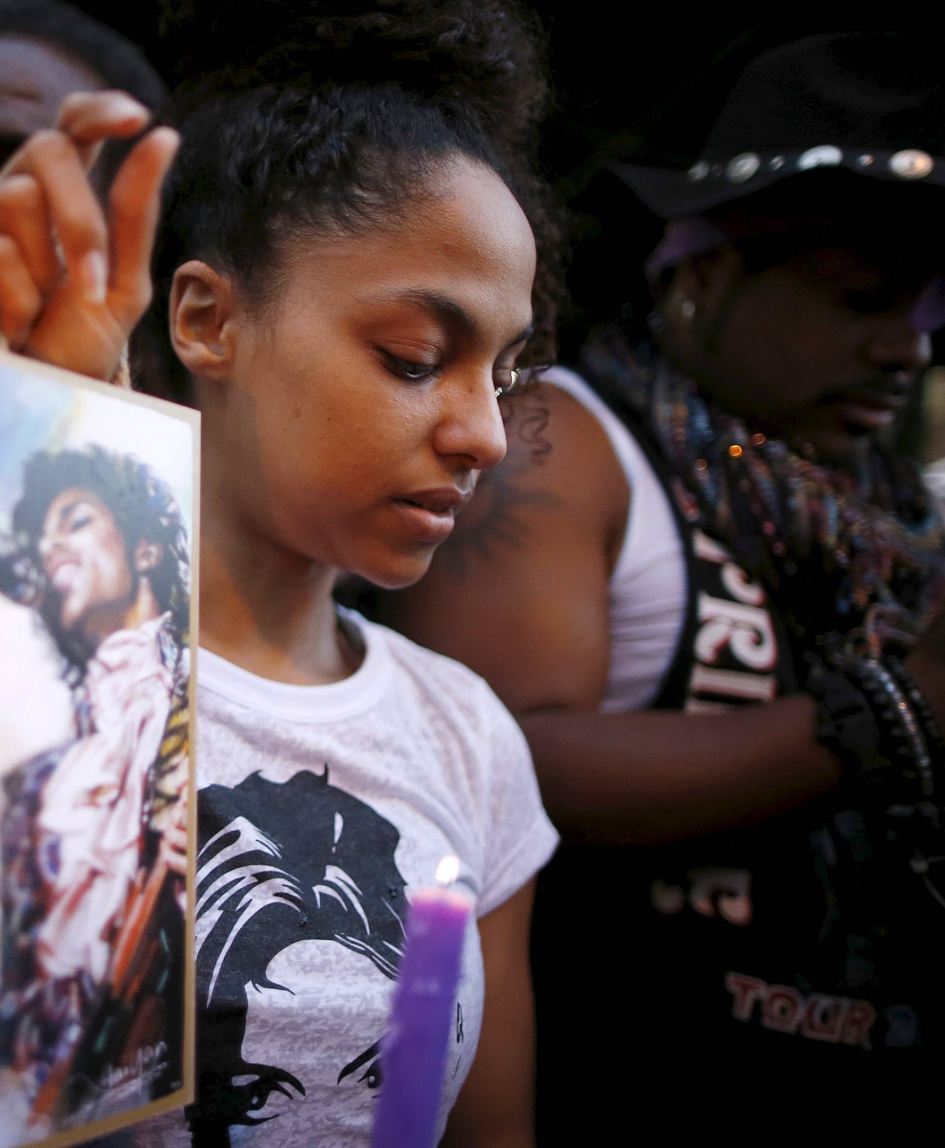 Julya Baer, 30, cries at a vigil to celebrate the life and music of deceased musician Prince in Los Angeles