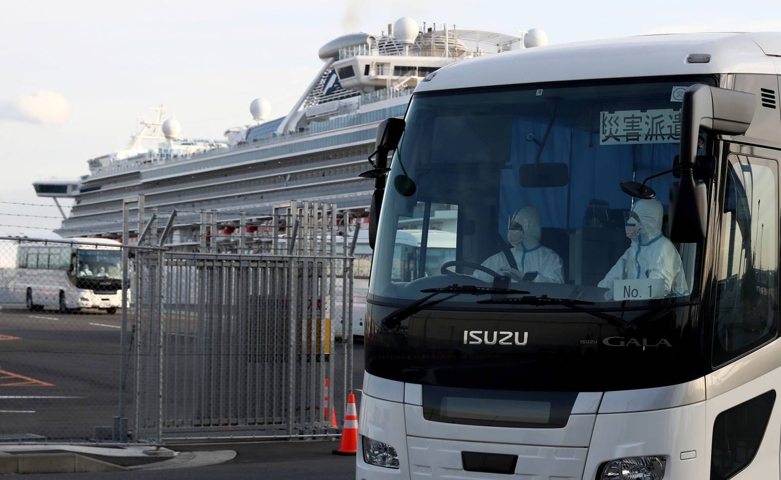 A bus believed to be carrying passengers from the cruise ship Diamond Princess, leaves Daikoku Pier Cruise Terminal in Yokohama