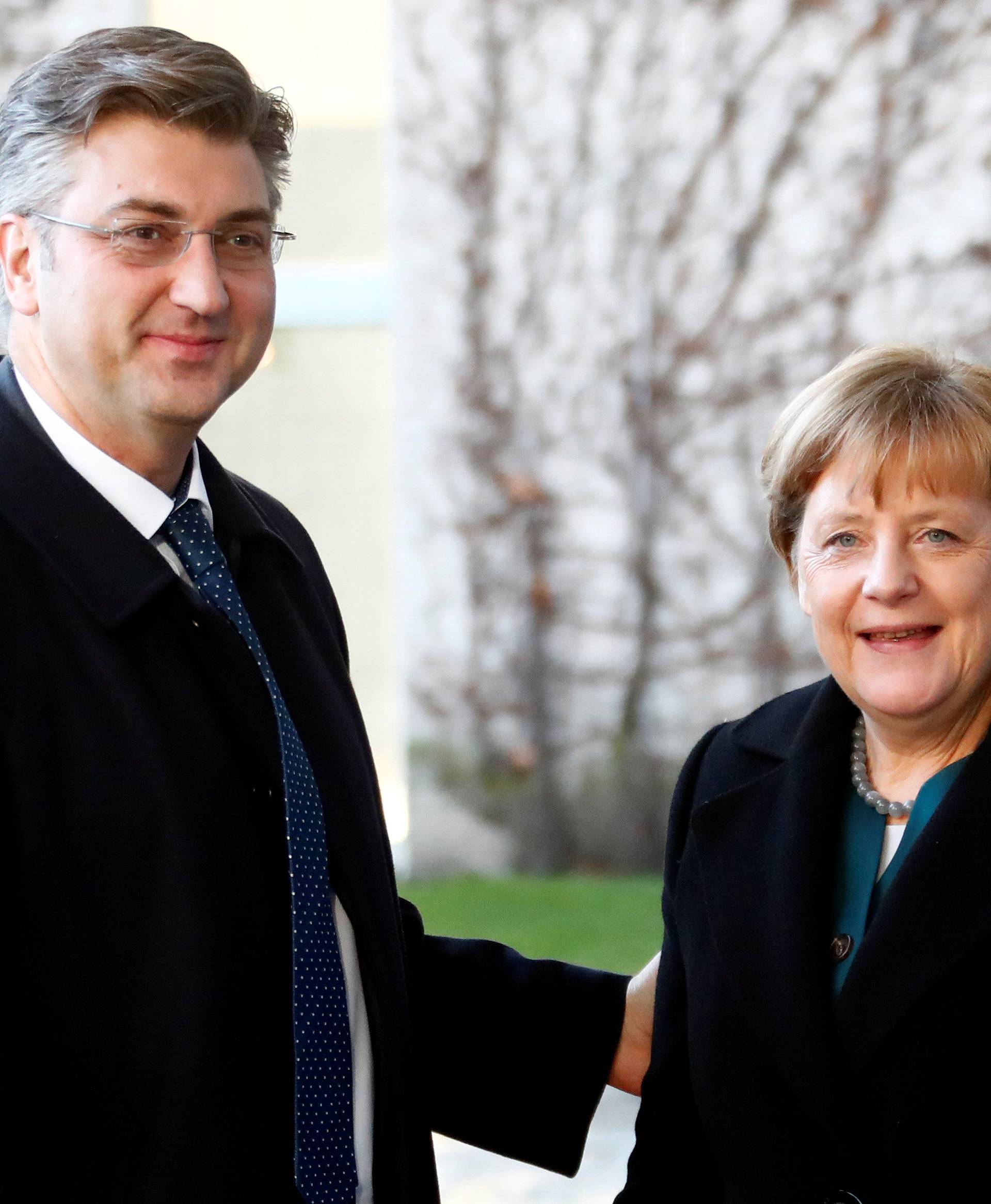 Croatia's Prime Minister Plenkovic is welcomed by German Chancellor Merkel at the chancellery in Berlin