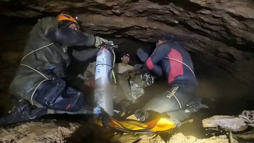 Rescue divers share the equipment usage guidelines with people trapped inside a cave during their rescue mission in Xaisomboun Province