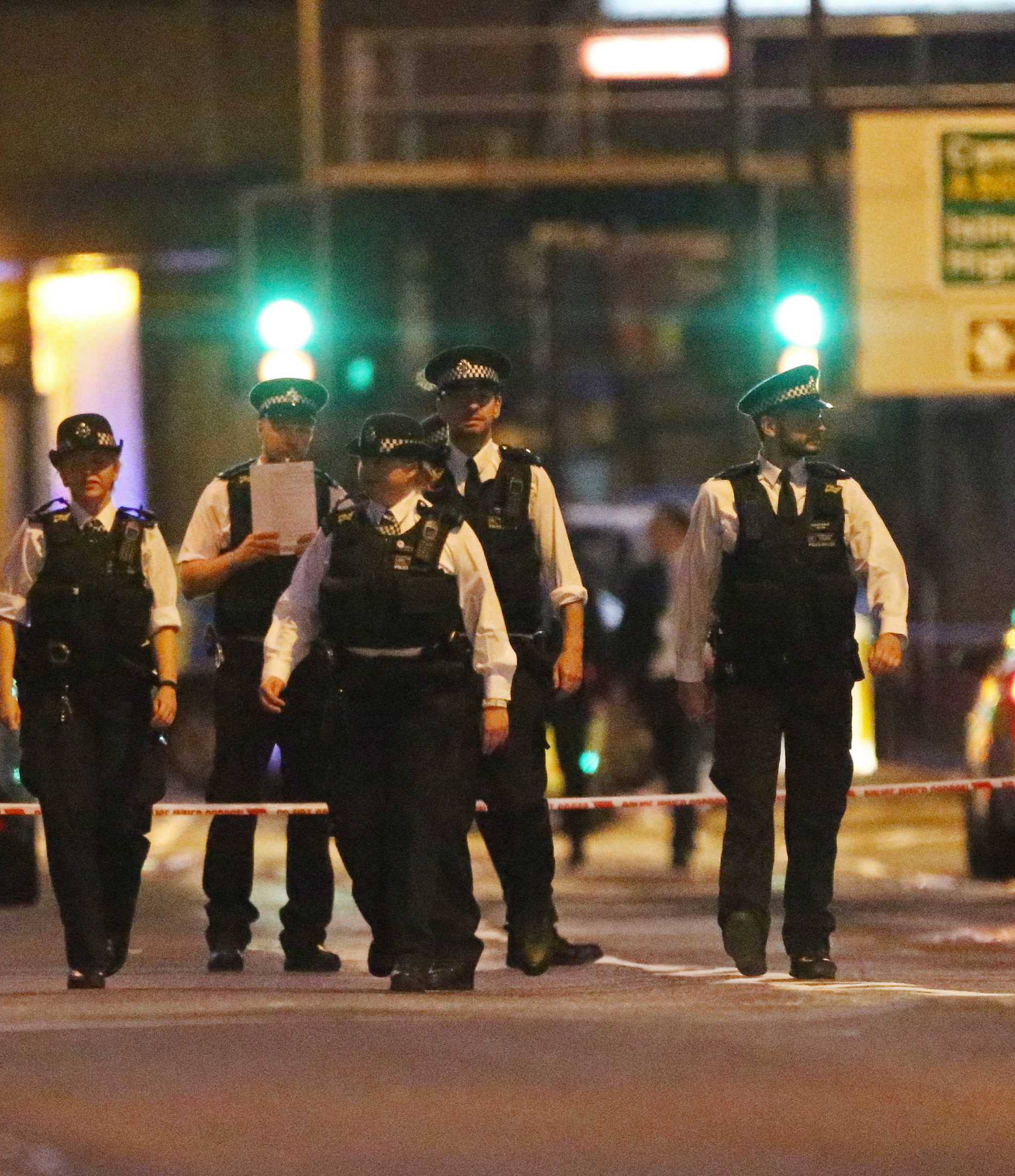 Police officers attend to the scene after a vehicle collided with pedestrians in the Finsbury Park neighborhood of North London