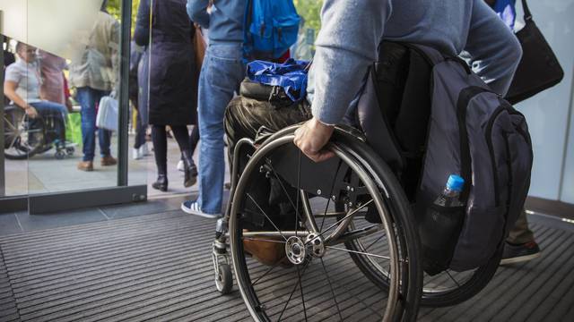 Man in wheelchair leaving office